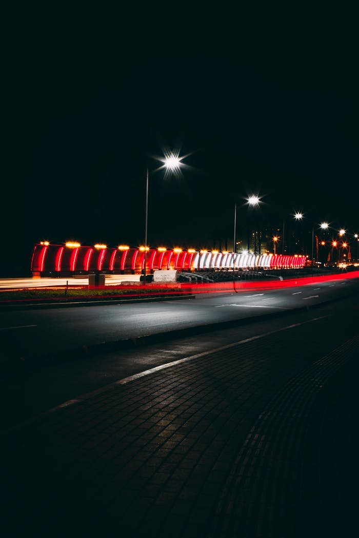 A captivating night view of an illuminated street in Miraflores, showcasing vibrant lights and a serene urban atmosphere.